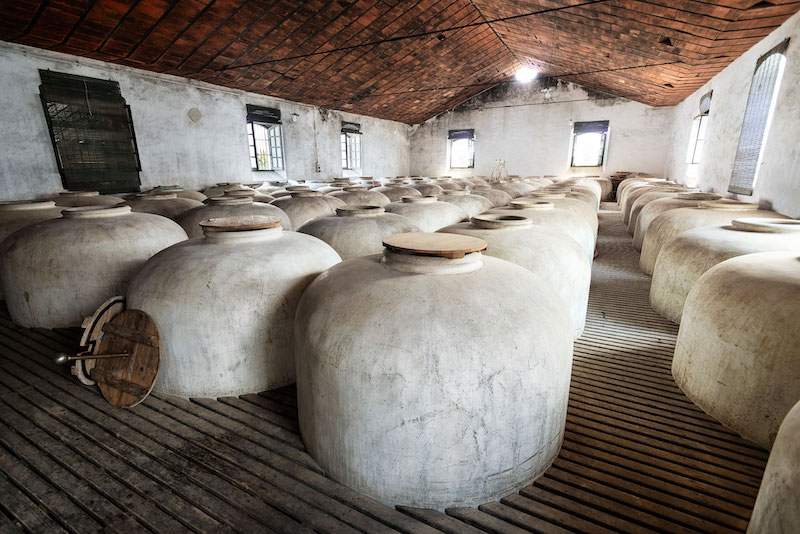 The ultra-sweet must settles in tinajas (traditional clay/concrete jars) and is fortified to ~16% ABV to stop fermentation. 