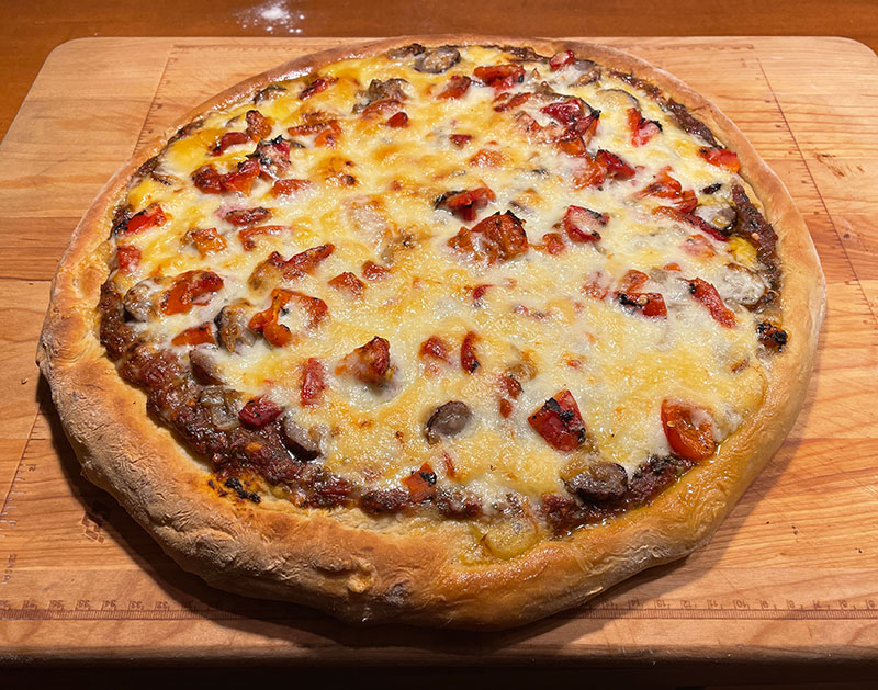 This pizza features Italian sausage , sweet peppers, and onions.