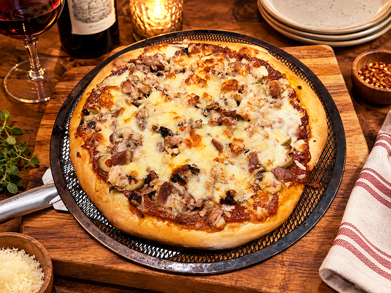 This pizza features leftover Turkey, Green Olives, and Sun-dried Tomatoes.